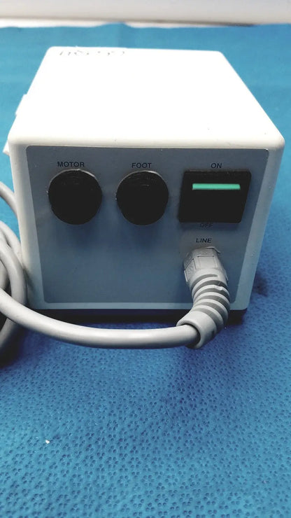 White rectangular electric foot massage machine with black controls and green power switch by sybronendo tcm endo iii