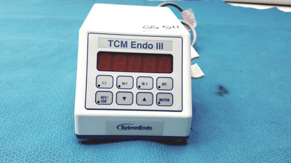 White plastic sybronendo tcm endo iii medical device with red digital display and control buttons labeled tcm endo iii