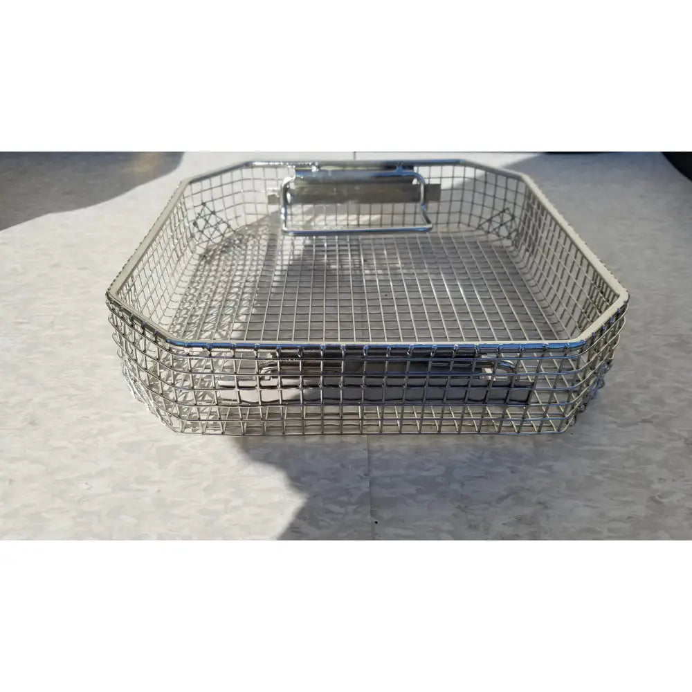 Silver wire mesh basket with sturdy metal handle in the symmetry medical flashpak 9020 sterilization container system