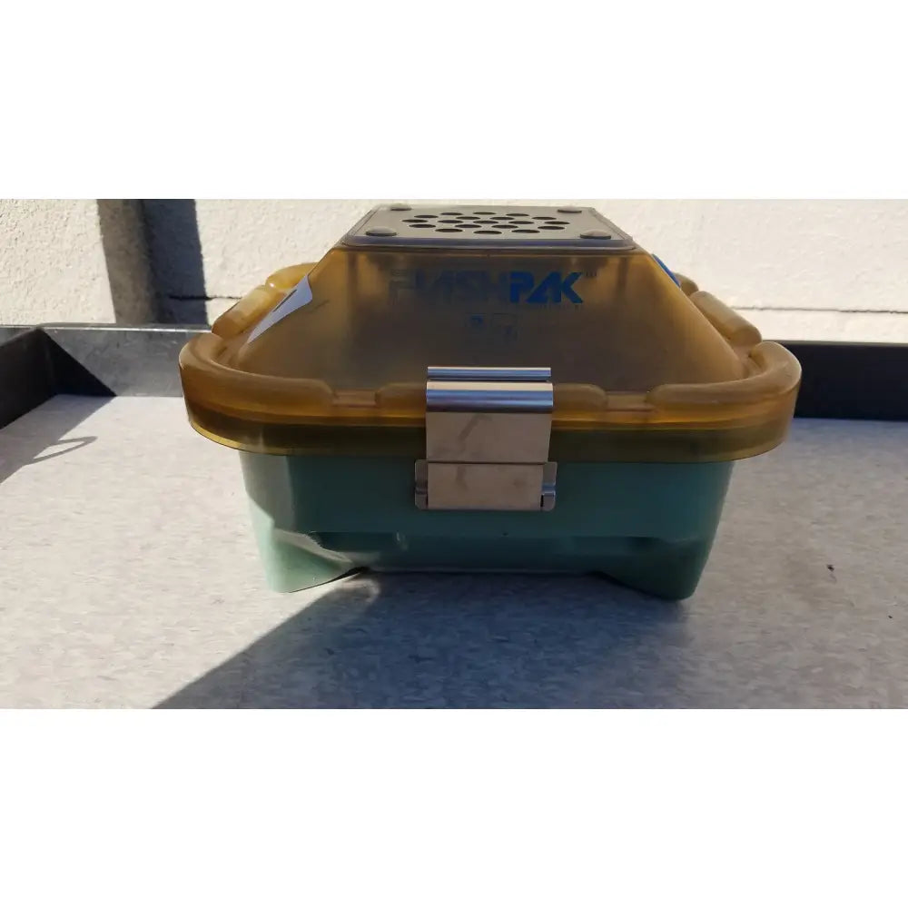 A teal and translucent yellow symmetry medical flashpak sterilization container system with a silver metal latch branded husqvarna