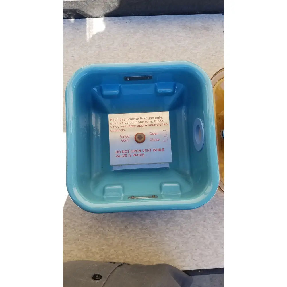 Blue plastic ice bucket with vent valve and instructional label in symmetry medical flashpak 9020 sterilization container system
