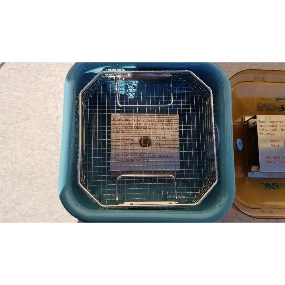 Blue plastic ultrasonic cleaner with metal mesh basket inside for symmetry medical flashpak 9020 sterilization system