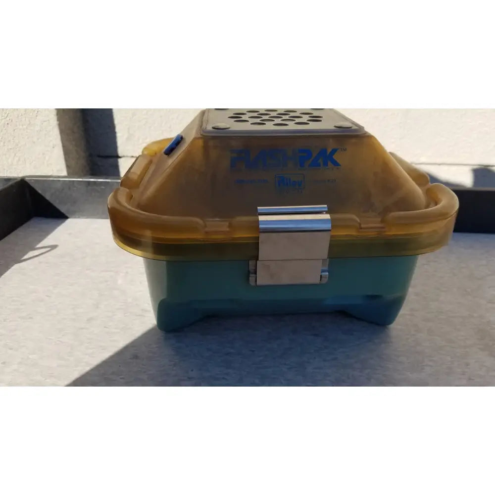 Symmetry medical flashpak sterilization container system with teal and translucent yellow plastic carrier and silver latch