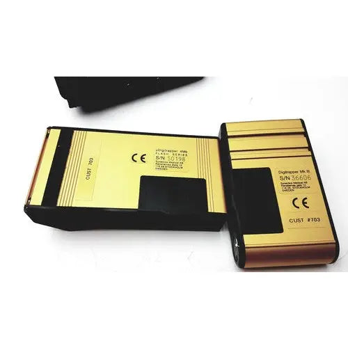 Gold and black rectangular battery packs with metallic finish for synectics digitrapper 4mb data storage device