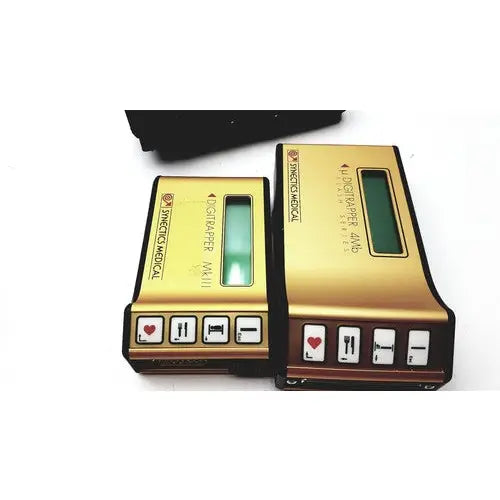 Gold-colored digital medical devices with green screens and black buttons on synectics digitrapper 4mb units