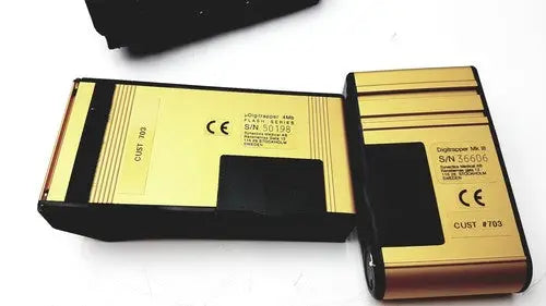 Gold and black rectangular battery packs with metallic finish for synectics digitrapper 4mb data storage device