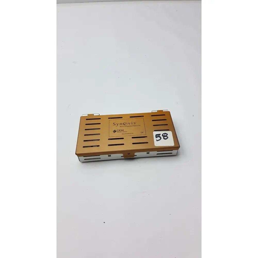 Bronze-colored metal synovis gem precision instrument case with ventilation slits and white label number 58