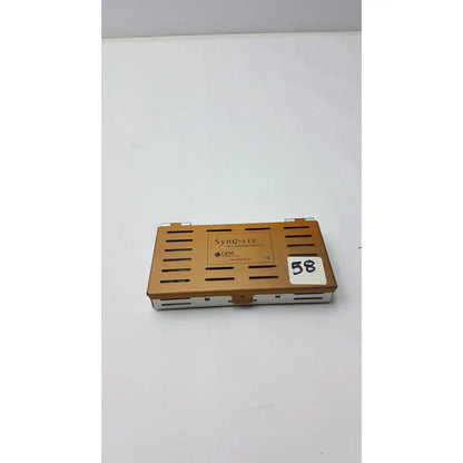 Bronze-colored metal synovis gem precision instrument microtray organizer case with horizontal slits and labeled synovix