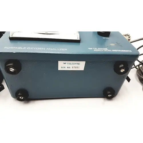 Blue teledyne portable oxygen analyzer with black knobs and white serial number label for accurate oxygen measurement