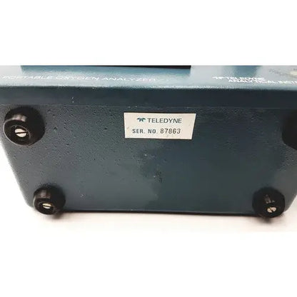 Teledyne portable oxygen analyzer with dark teal metallic casing and black rubber feet for portable oxygen use