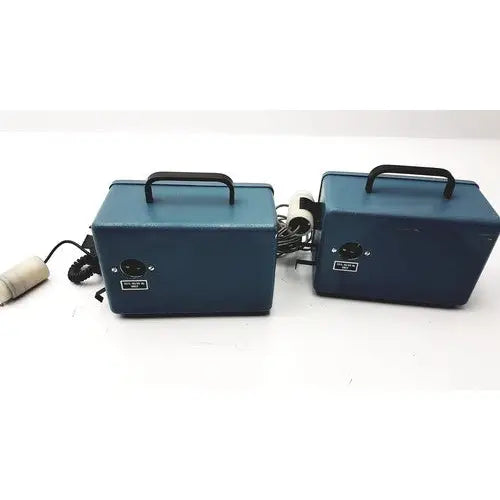 Two matching blue rectangular teledyne portable oxygen analyzers with black handles and coiled cords for easy transport