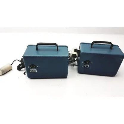 Two matching blue rectangular teledyne portable oxygen analyzers with black handles and coiled cords for easy transport