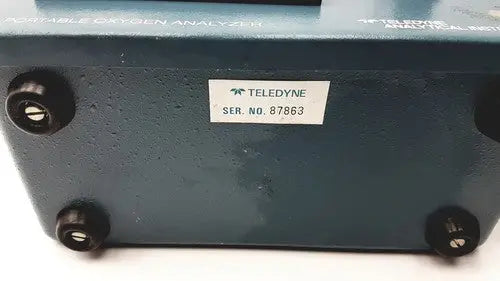 Teledyne portable oxygen analyzer with dark teal metallic casing and black rubber feet for portable oxygen use