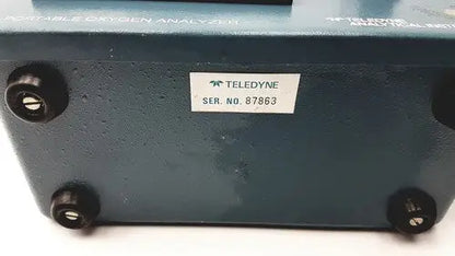 Teledyne portable oxygen analyzer with dark teal metallic casing and black rubber feet for portable oxygen use
