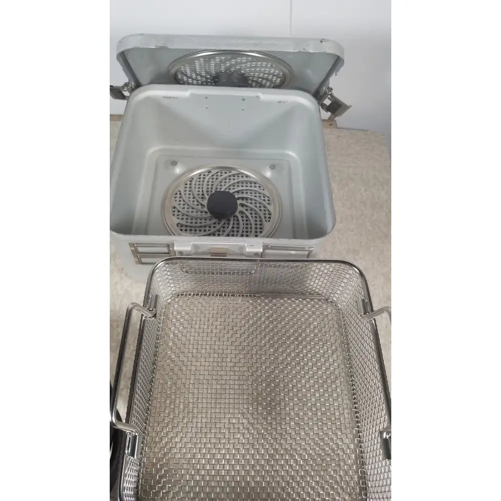 Silver stainless steel deep fryer basket with mesh design and side handles from the case genuis serial no 9354 patent pending