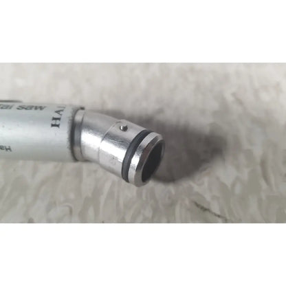 Silver-colored metal pen with black rubber gasket tip from the case genuis serial no 9354 patent pending collection