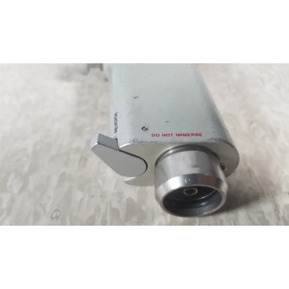 Silver metallic cylindrical camera housing with prominent lens port and side lever from case genuis serial no 9354 patent pending