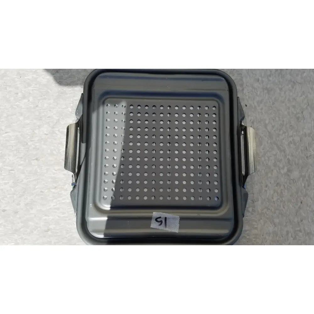Gray perforated metal baking tray with side handles for the case sterilization container half lid black