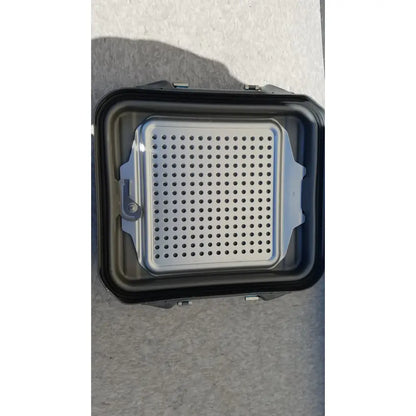 Black plastic case sterilization container half with silver perforated metal grilling tray and container half lid