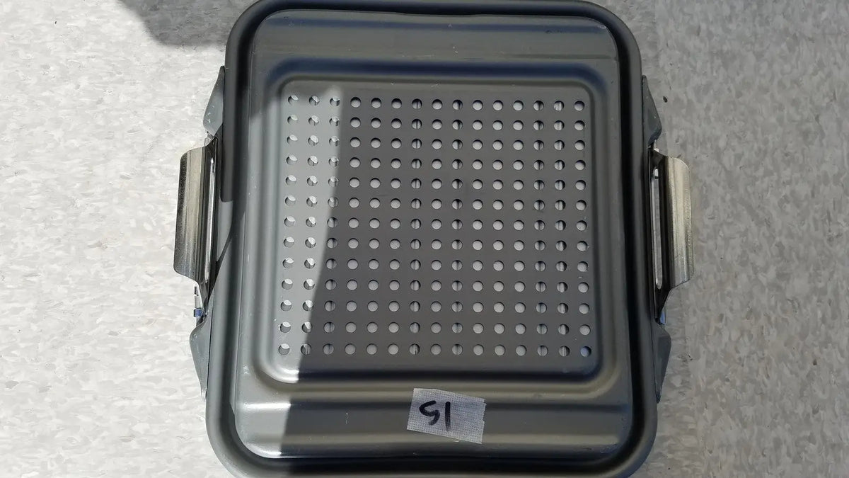 Gray perforated metal baking tray with side handles for the case sterilization container half lid black
