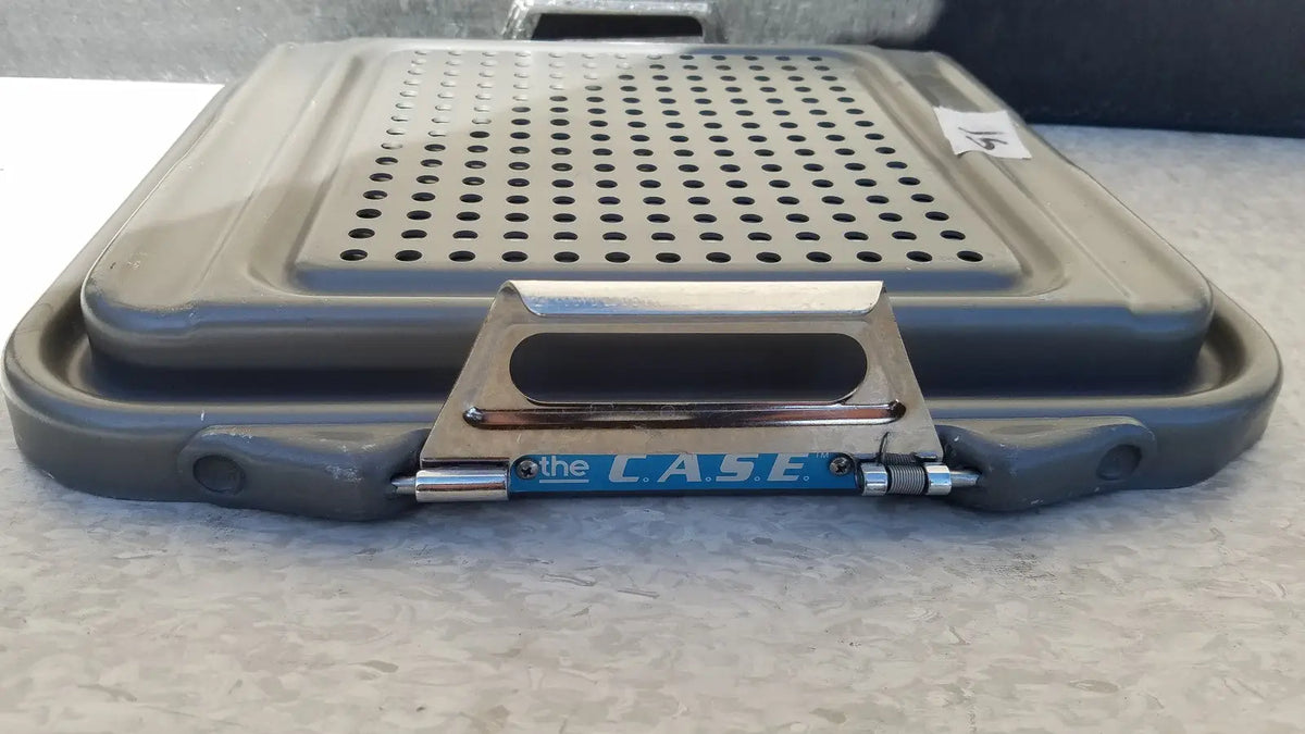 Gray plastic case sterilization container half lid black with perforated lid and metallic handle branded the case in blue lettering