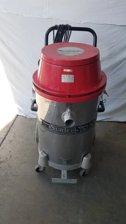 The Surtec System 450M red and silver wet dry drum vacuum with black handle and wheels for heavy duty use