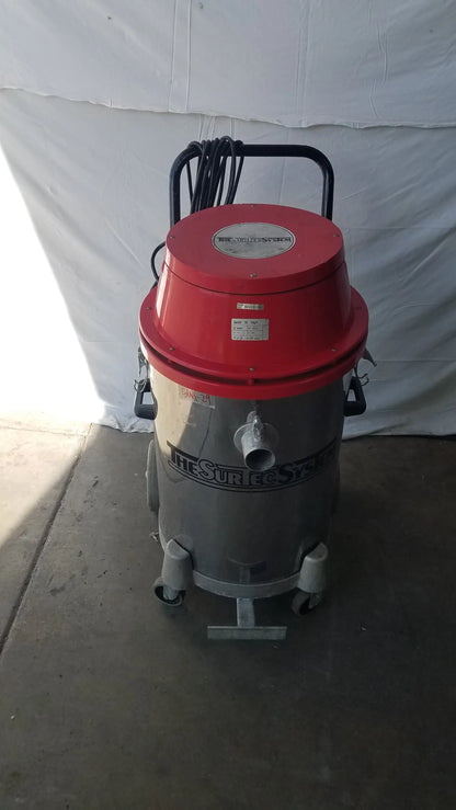 The Surtec System 450M red and gray wet dry drum vacuum cleaner with black handle and wheels for industrial use