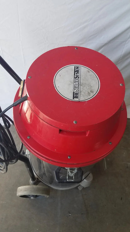 Red circular top with the sire system logo on a metallic plate mounted on a gray wet dry drum vacuum cleaner body