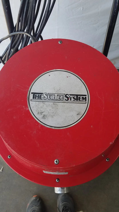 Red circular wet dry drum vacuum with the sureco system logo on a silver center plate for industrial use