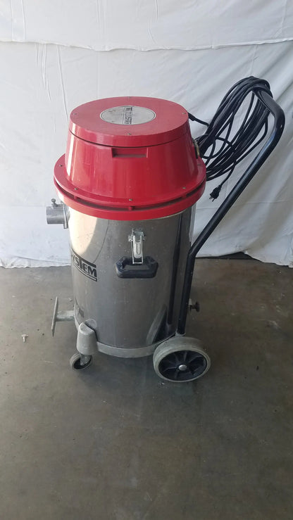 The Surtec System 450M red and silver wet dry drum vacuum cleaner with black handle and wheels for industrial use