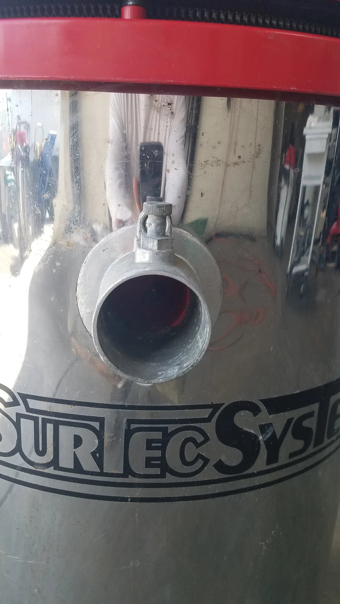 The Surtec System 450M silver cylindrical wet dry drum vacuum cleaner with red top and black surec system branding