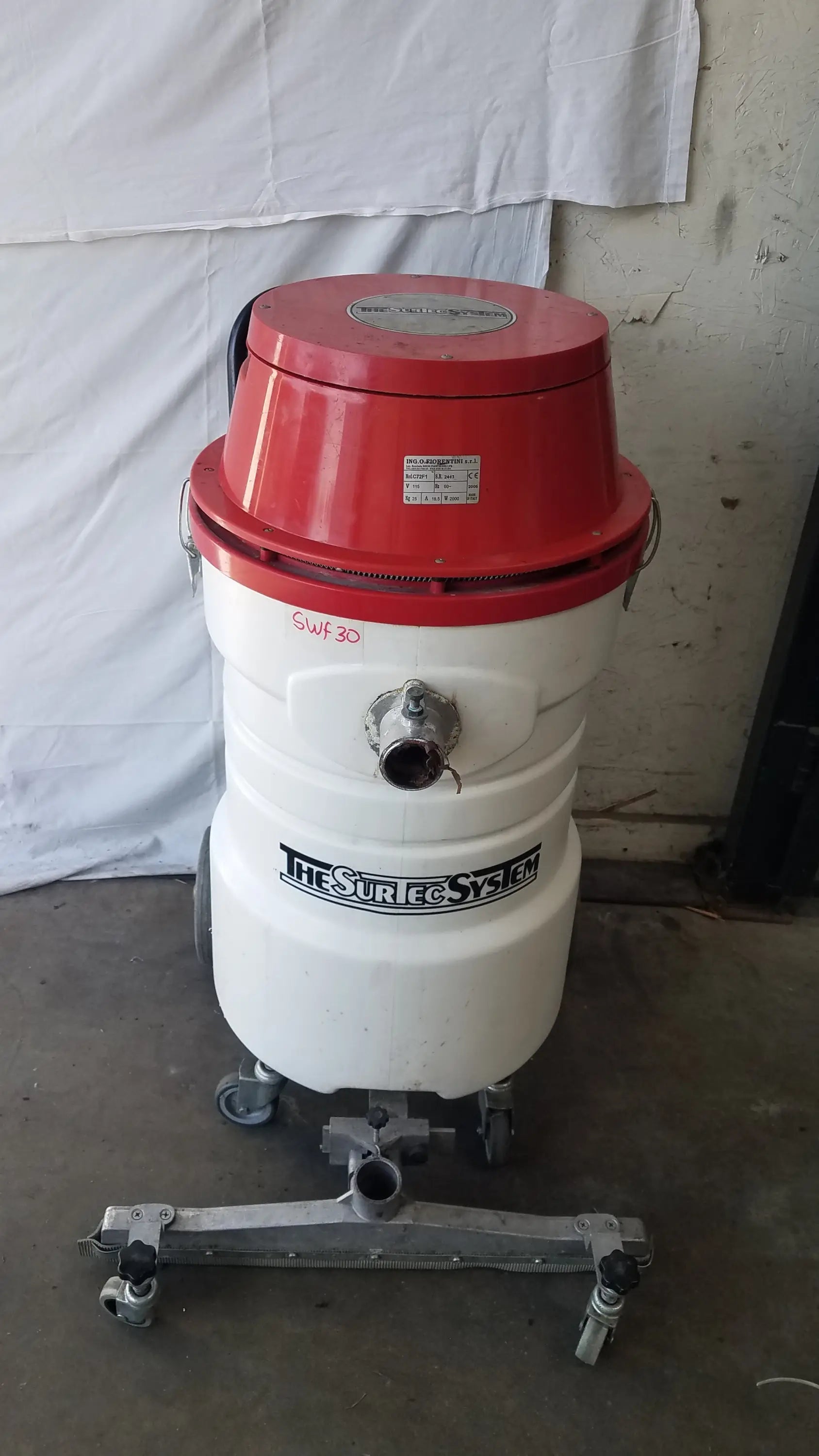 The Surtec System C72F1 wet dry vacuum cleaner 115V is a red and white industrial dry vacuum with metal fittings and casters