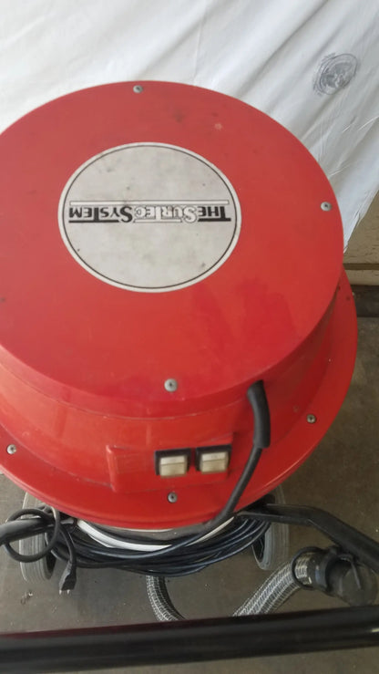 Red circular wet dry vacuum cleaner the surtec system c72f1 with white label and two black power switches on side