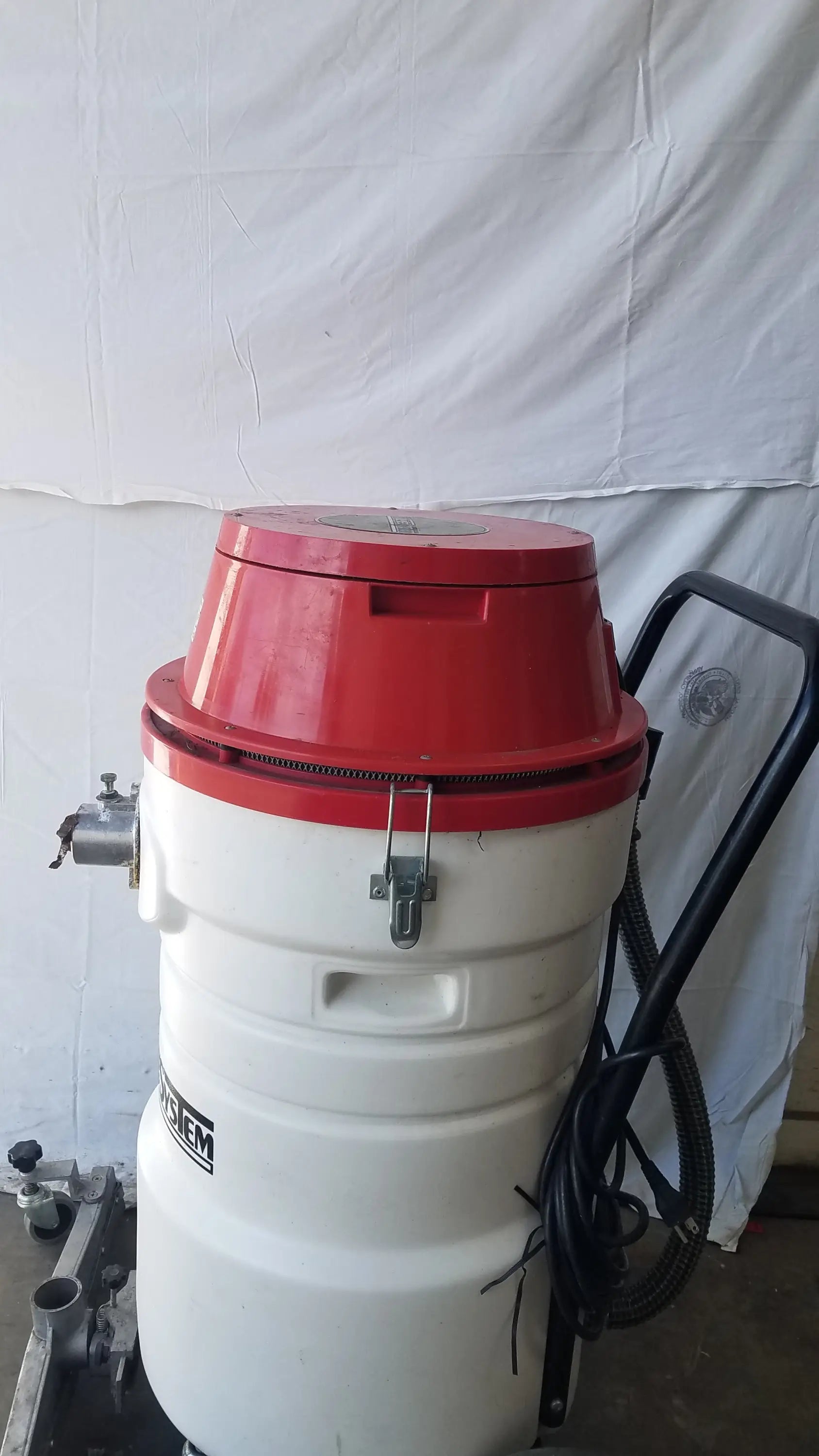 The Surtec System C72F1 red and white wet dry vacuum cleaner with black handle and hose for industrial use