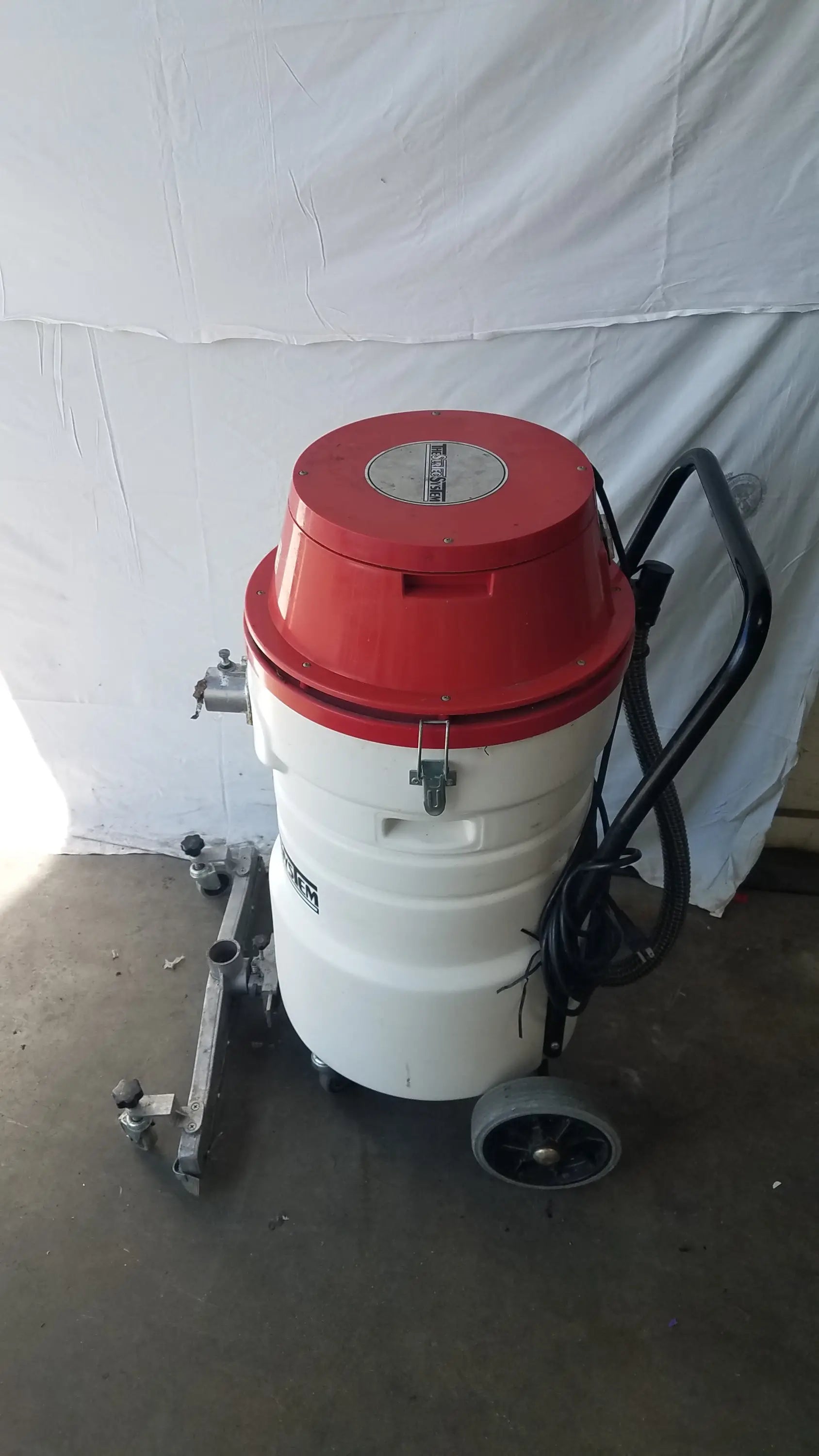 Red and white Surtec system C72F1 wet dry vacuum cleaner with black handle and wheels for wet dry and dry vacuum use