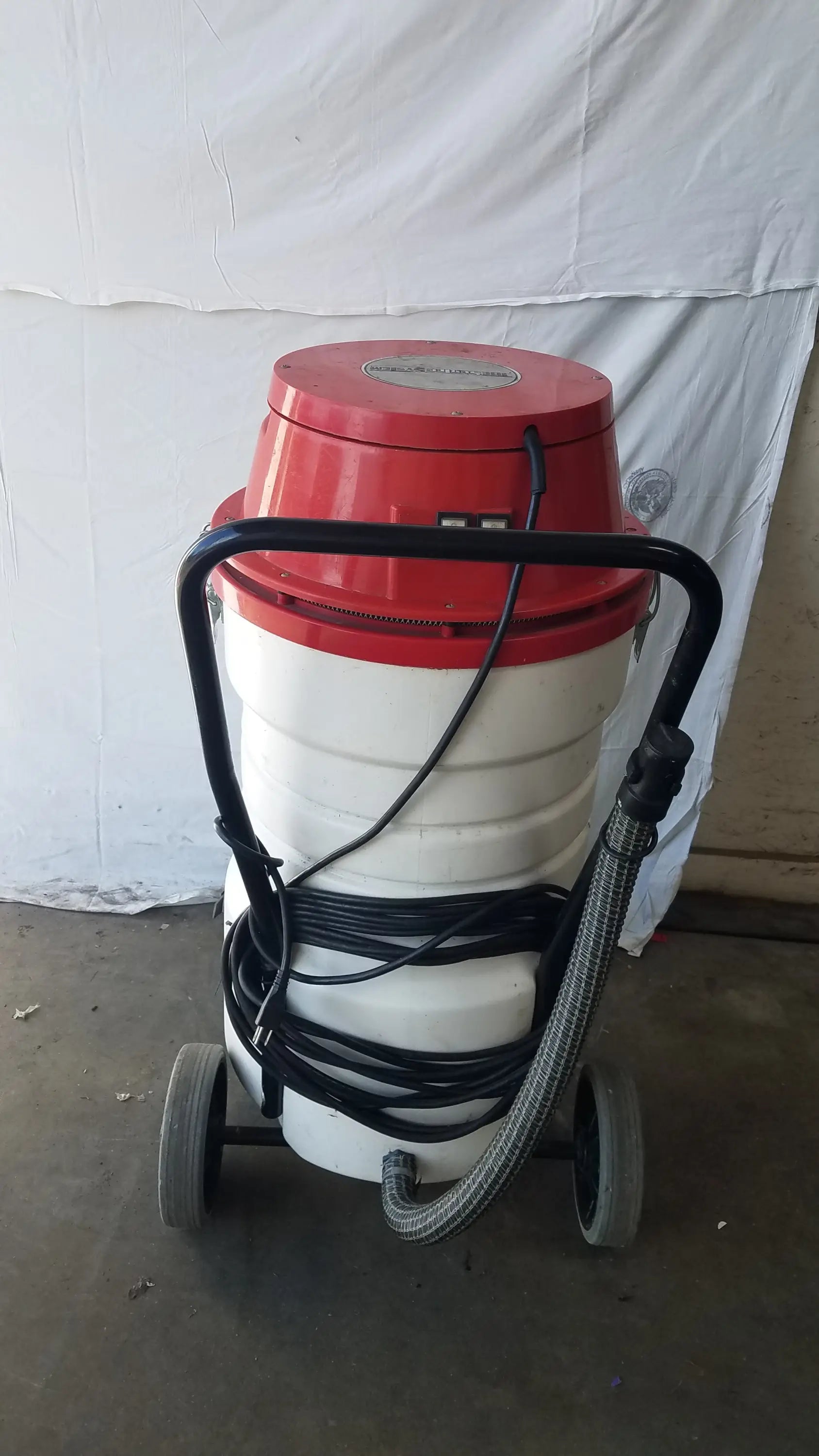 The Surtec System C72F1 wet dry vacuum cleaner in red and white with black handle hose and wheels for wet dry use