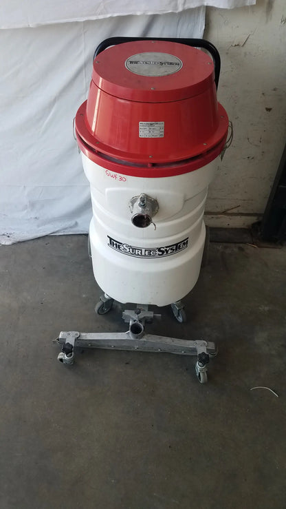 The surtec system c72f1 wet dry vacuum cleaner 115v with red and white cylindrical body and metal caster wheels