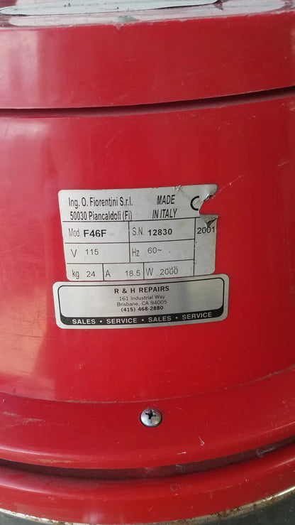 Red industrial fan with metallic label showing specifications on the back of the Surtec System F46F wet dry drum vacuum