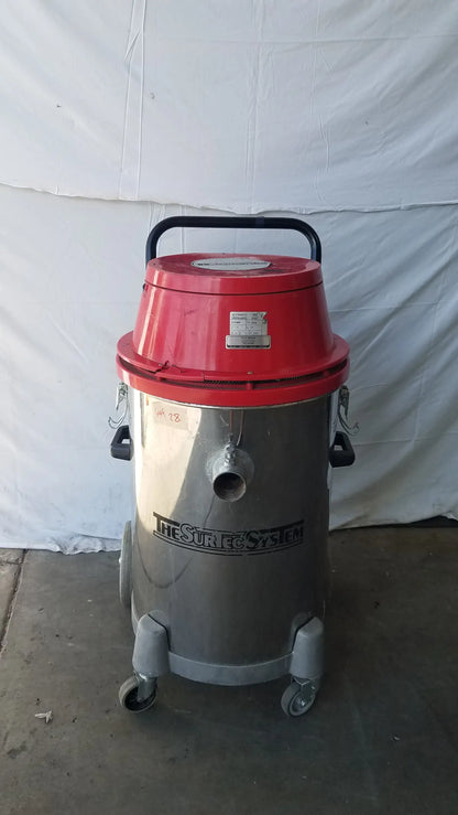 Red and silver wet dry drum vacuum cleaner with black handle and wheels branded the stric system for industrial use