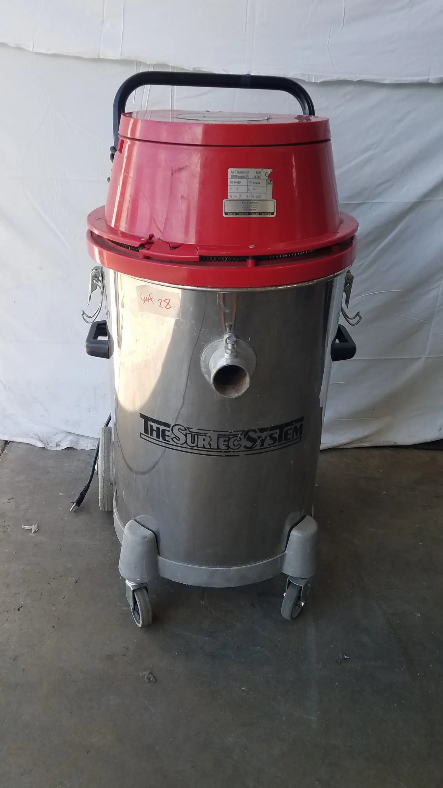 The Surtec System F46F red and silver industrial wet dry drum vacuum with black handle for heavy duty use