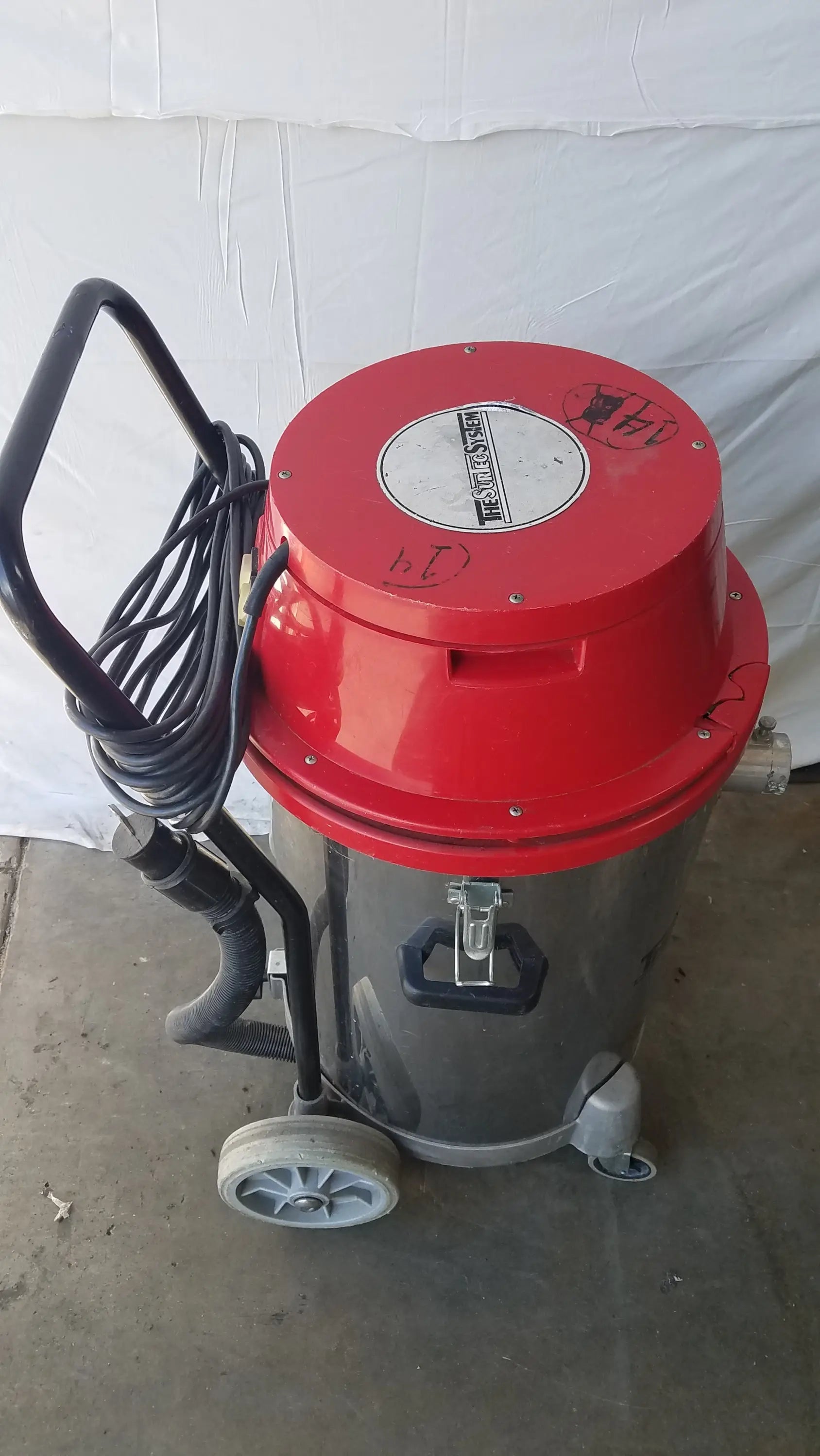 The surtec system f46f red and gray wet dry drum vacuum cleaner with black handle coiled hose and wheels for industrial use