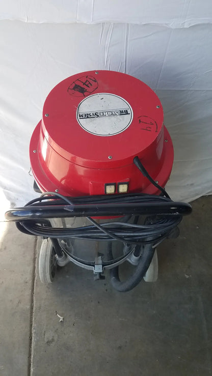 The surtec system f46f red cylindrical wet dry drum vacuum cleaner with black hose and white wheels for industrial use