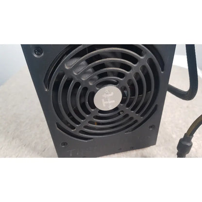 Black rectangular thermaltake 1350w toughpower gf3 full modular power supply with circular fan and silver logo plate