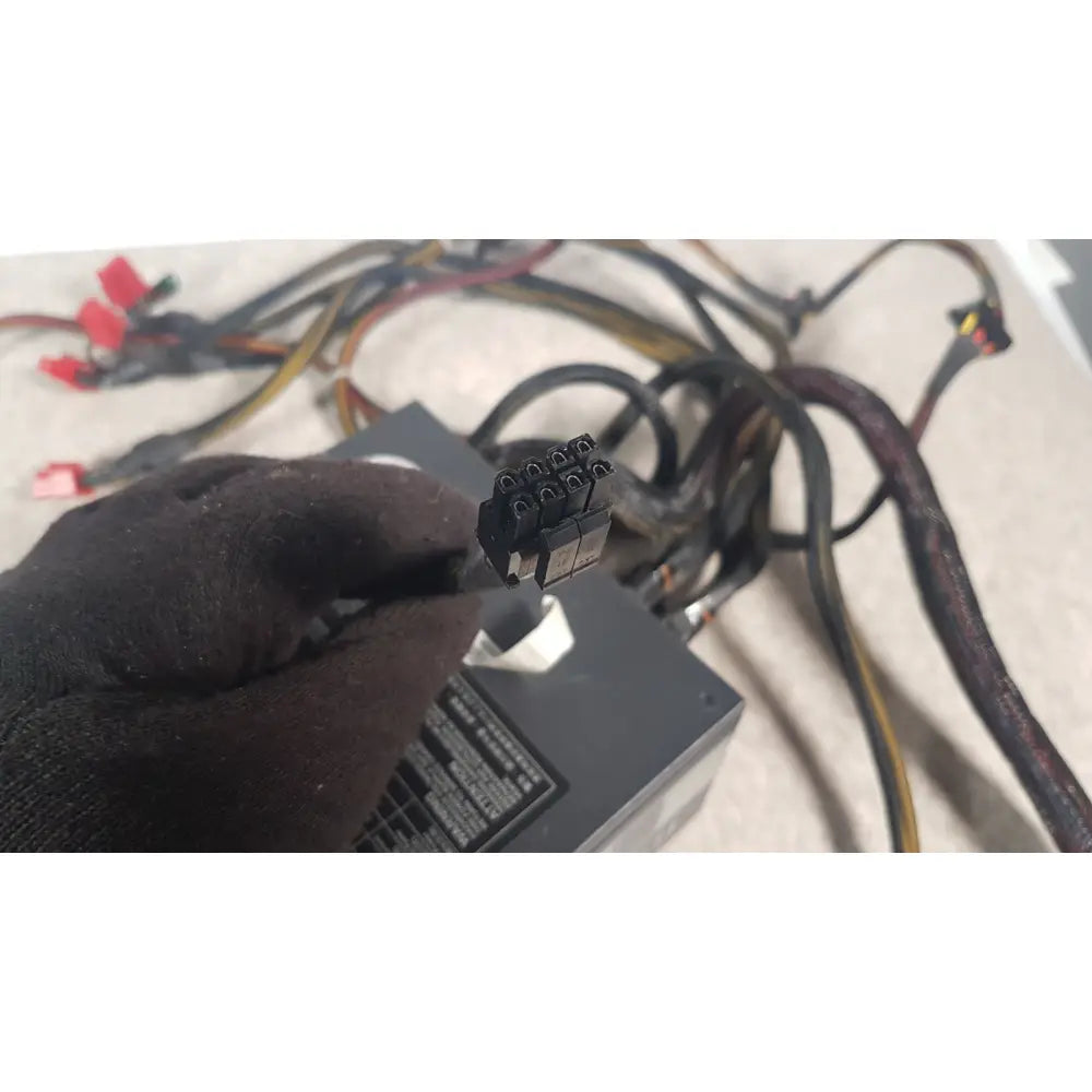 Black 8-pin pcie power connector held in gloved hand for thermaltake 1350w toughpower gf3 full modular psu
