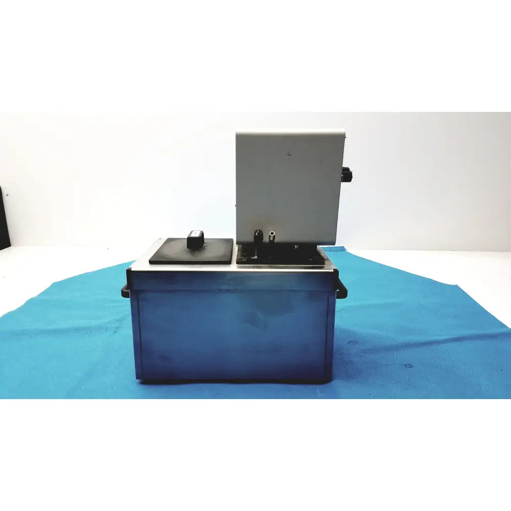 Gray and black laboratory-grade thermo haake dc3 heating circulator bath with hinged lid metallic base and control knobs