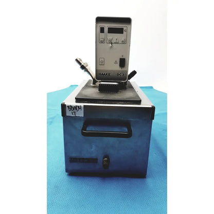 Silver and black thermo haake dc3 heating circulator bath with digital display and front handle for precise temperature control