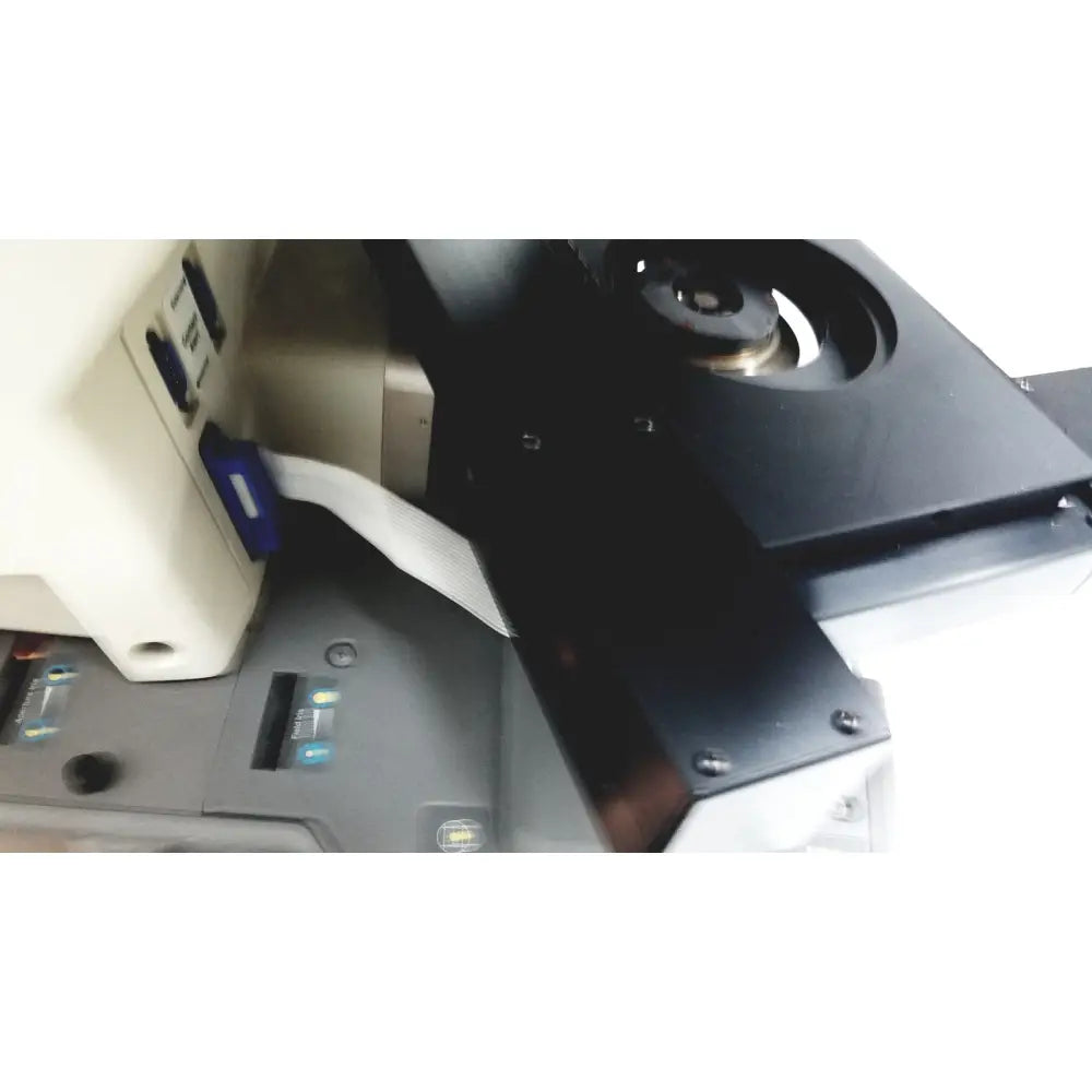 Black plastic component with circular cutout and metallic screws on the back side of thermo nicolet continuum infrared microscope