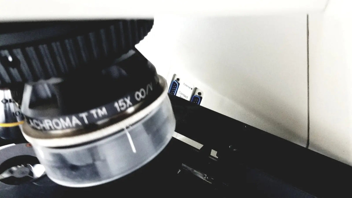 A black 15x objective lens with a clear cylindrical body and ridged focusing ring for thermo nicolet continuum infrared microscope