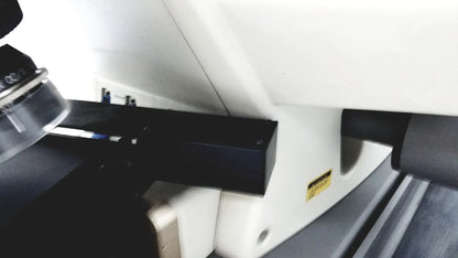 Black rectangular component mounted on white base of thermo nicolet continuum infrared microscope for precise analysis