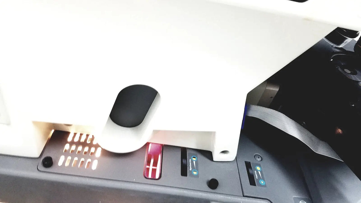 White plastic car charging station with black and red buttons for thermo nicolet continuum infrared microscope use